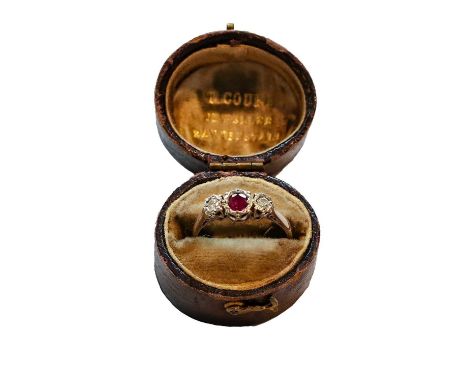 An 18 carat white gold ruby and diamond three stone ring, finger size NGross weight 3.0 grams.