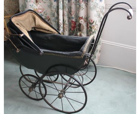 AW Gamages, London, Victorian dolls twin pram with black painted wooden body, black rexine hood and two seats interior. Four 