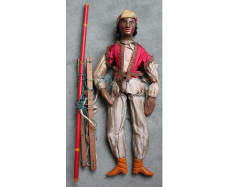 An Indian style gentleman string puppet. Italian 1900's with black painted carved wood features. Dressed with Turban and red 