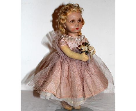 Bridesmaid' a Deans Rag Book cloth doll, English circa 1950's. Having a pressed moulded cloth face with fine oil painted feat