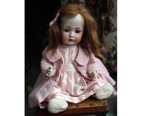 Bruno Schmidt, B.S.W. German 1900's. A bisque head baby doll with sleeping brown glass eyes, open mouth, one upper tooth (one