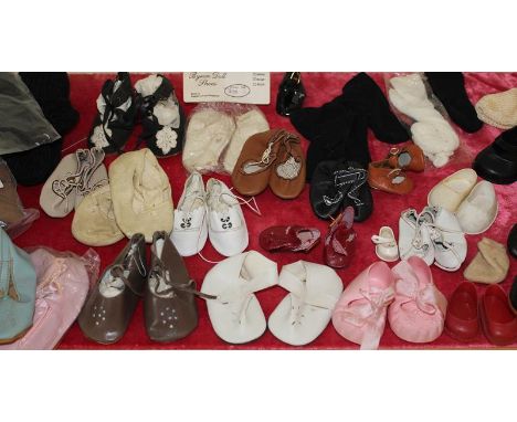 A quantity of vintage and modern dolls shoes and socks. (qty)