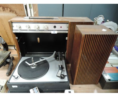 A vintage portable Ferguson record player with fold down deck and speaker.