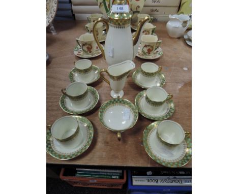 A Royal Doulton part coffee service comprising of coffee pot,creamer,sugar basin and six cups and saucers having green and gi