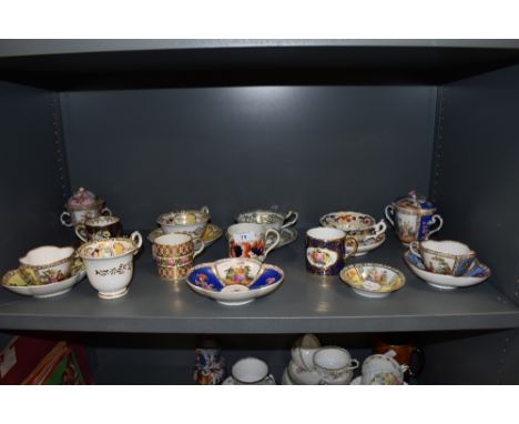 A fine selection of antique and later tea and coffee cups including Crown Derby Rockingham style and Meissen chocolate cup an