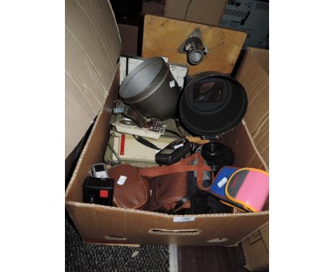 A box full of mixed cameras and equipment including Kodak Instamatic, universal exposure meter and more.