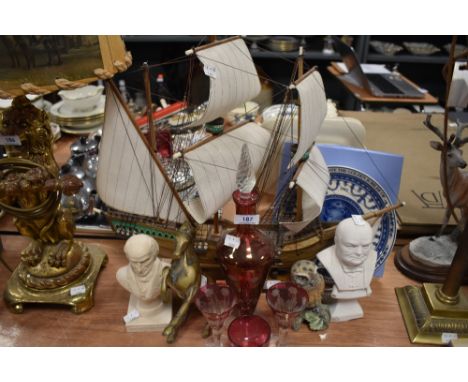 A selection of trinkets including heavy cast horse figure and etched cranberry decanter and glasses