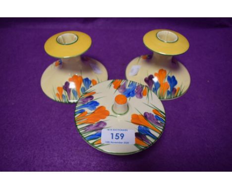 Thee item of Bizarre, Crocus by Clarice Cliff Newport potteries,A pair of candlestick holders and a lidded pot.
All pieces ve