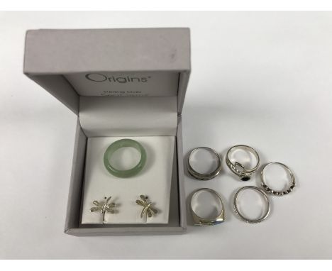 A number of contemporary white metal (tested as silver) dress rings, a jade ring and a pair of dragonfly ear studs