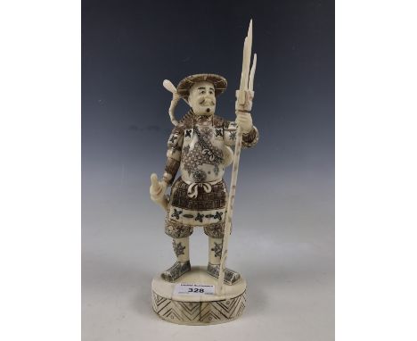 A Japanese bone okimono of a warrior with trident, 23 cm
