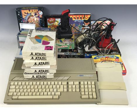 An Atari 1040ST games console together with a quantity of games