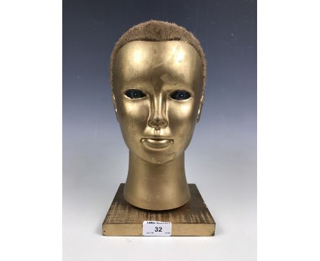 A gilt mannequin head