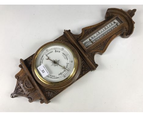 A Victorian carved oak banjo barometer