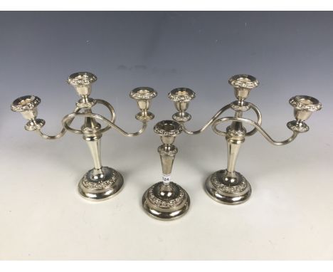A pair of electroplate candelabra together with a matching candlestick