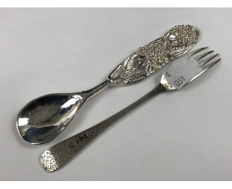 A silver fork together with a spoon