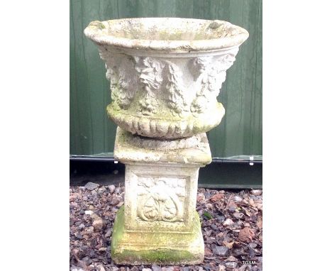 A large stone garden planter on stand