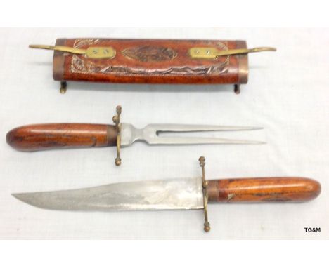 An unusual carving knife and fork set in a carved wooden sheath/case 46cm long