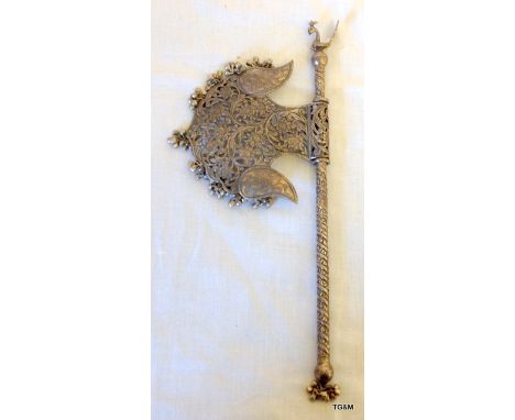 A large Indian white metal child's rattle in the shape of an axe 30cm long