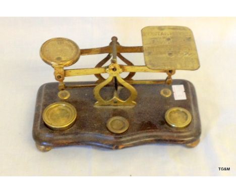 A set of Edwardian postal scales with weights on wooden base