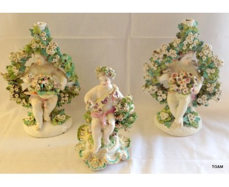 Pair of Derby candlestick groups c.1770 each of Putto seated beneath flowering arbour and  a further model of a Putto seated 