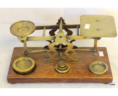 A set of Edwardian postal scales with weights on wooden base
