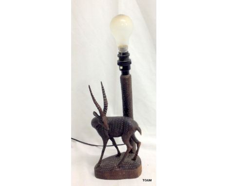 A vintage Tribal art carved lamp depicting an antelope