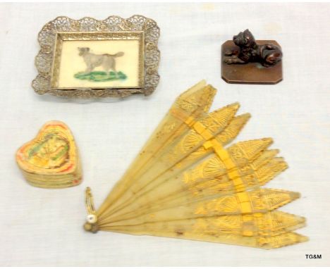 A collection of regency items including a horn fan and a dog tapestry
