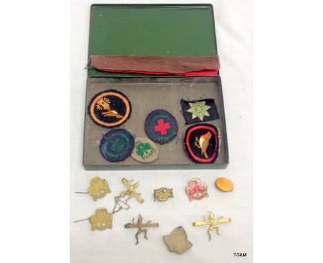 A quantity of girl guide patches and badges including enamel