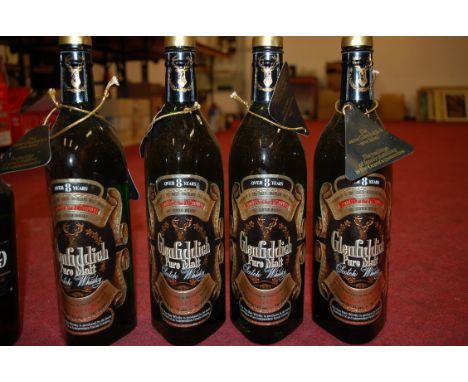 Glenfiddich pure malt scotch whisky, aged 8 years, 26⅔fl.ozs, 70° proof, four bottles; Vat 69 whisky, one bottle; and Old Gra