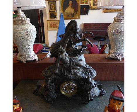 A late 19th century French spelter mantel clock, drum movement, striking bell, the case with Classical maiden knelt by a rear