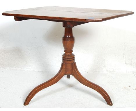 A 19th Century George III mahogany tilt top pedestal wine table. Having a rectangular top with chamfered corners being raised