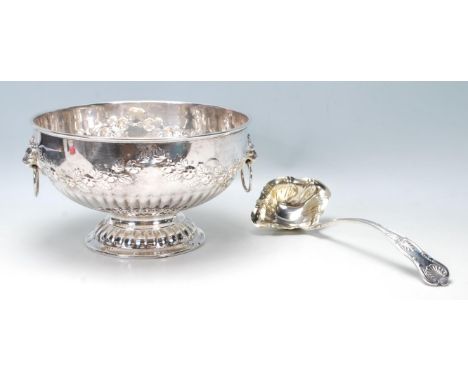 An antique style 20th Century large silver on copper bowl / ice bucket / champagne cooler having floral decoration to the bow