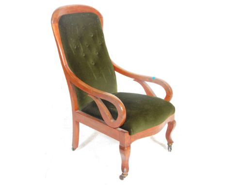 A Victorian 19th Century button back arm chair / library chair upholstered in green velour button backed fabric with shaped s