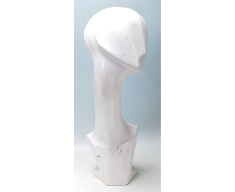 A contemporary abstract shop haberdashery, -advertising tabletop mannequin head finished in white of elongated stylistic desi