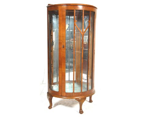 A 1930's art deco walnut veneered china display cabinet / vitrine. Raised on cabriole legs with pad feet supporting a demi ca