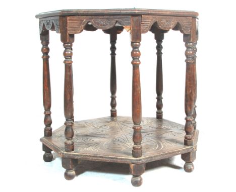 A 19th Century Victorian oak centre table of octagonal form having a carved table top over six turned supports on an under ti