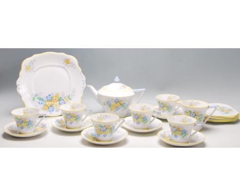 A vintage 1930's Bell china Art Deco tea service decorated with a printed yellow and blue pattern with hand applied colours, 