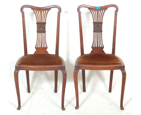 A pair of late 19th century Victorian Art Nouveau mahogany dining chairs / hall chairs having padded seats with copper studs,