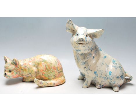 Two 20th Century ceramic large figurines in the form of a pig and a crouching cat each having layered transfer printed decora