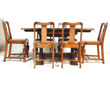A 1930's Art Deco vintage oak extendable draw leaf dining table and 6 chairs. The table having a rectangular top with leaf be