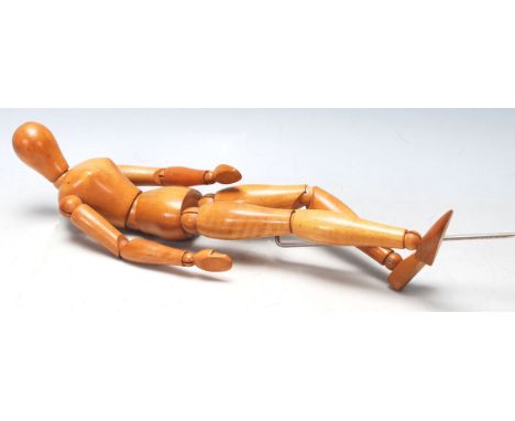 A vintage 20th Century fully adjustable wooden artist's mannequin / model figure. Measures 42cm long.&nbsp;