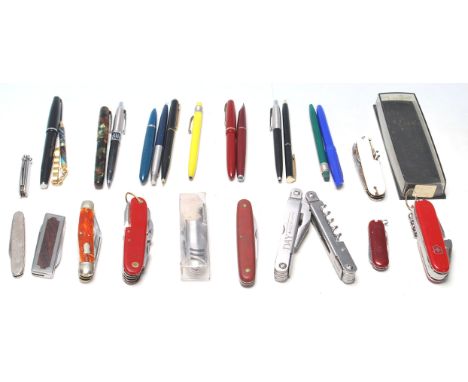 A good collection of writing pens and a Swiss penknife to include Parker pen, ball pen, fountain pen, together with other bal