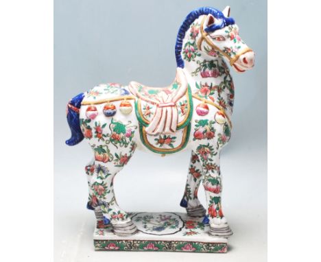 A 20th Century Chinese oriental Tang horse statue in the manner of Tang Dynasty with famille verte designed to the body raise