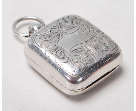 A silver hallmarked sovereign case having engraving decorations to the front and back with a push button lock and a spring ac