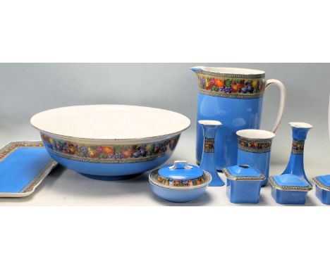 An early 20th century Wilkinson Ltd washbowl and jug together with a matching dressing table set having classical Greek key d