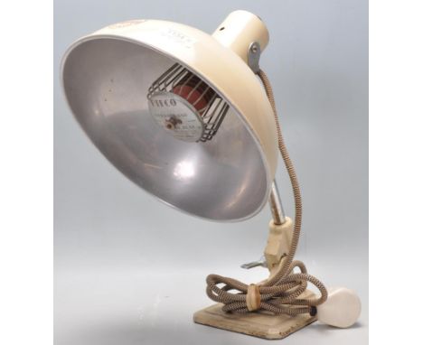 A retro vintage Industrial mid 20th century, circa 1960's Pifco infrared heat lamp coloured in beige set on a stepped base.Id