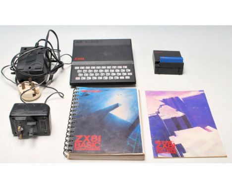 A retro vintage Sinclair ZX81 Computer, with a 16K RAM upgrade and power pack. Together with a ZX81 basic programming manual,