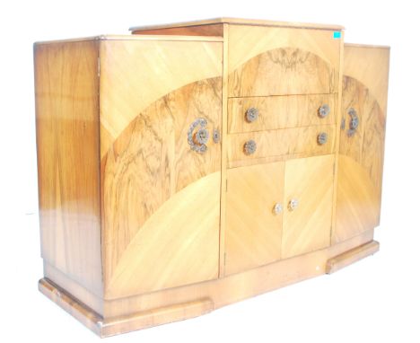 An early 1930’s Art Deco large walnut cocktail cabinet sideboard with central bank of drawers flanked by cupboards on each si