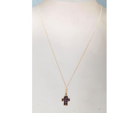 A 9 ct yellow gold and amethyst necklace having a crucifix shaped studded pendant&nbsp; on a cable chain with spring ring cla