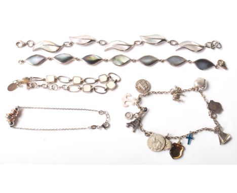 A group of stamped 925 silver bracelets to include two panel bracelets set with mother of pearl panelss, a fine link bracelet